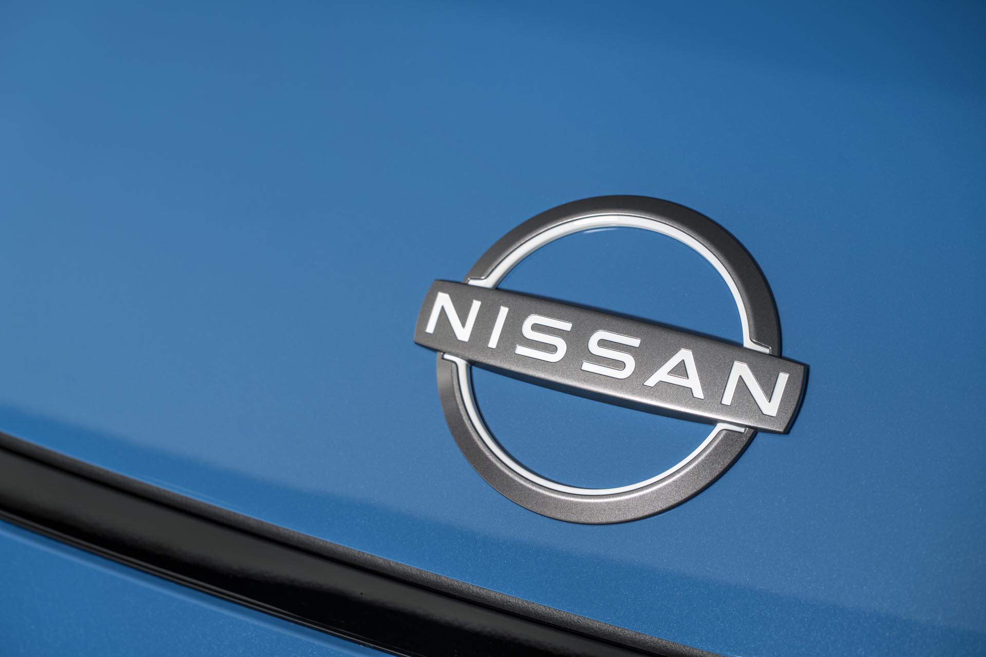 detailed Nissan logo nameplate on Blue micra body