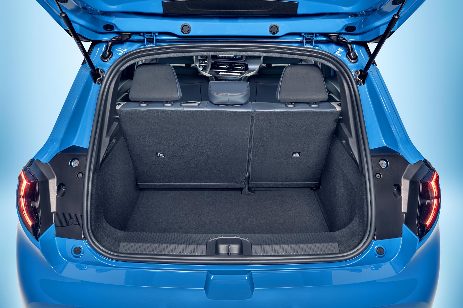 focused view of Micra trunk space with open trunk door with upright seats