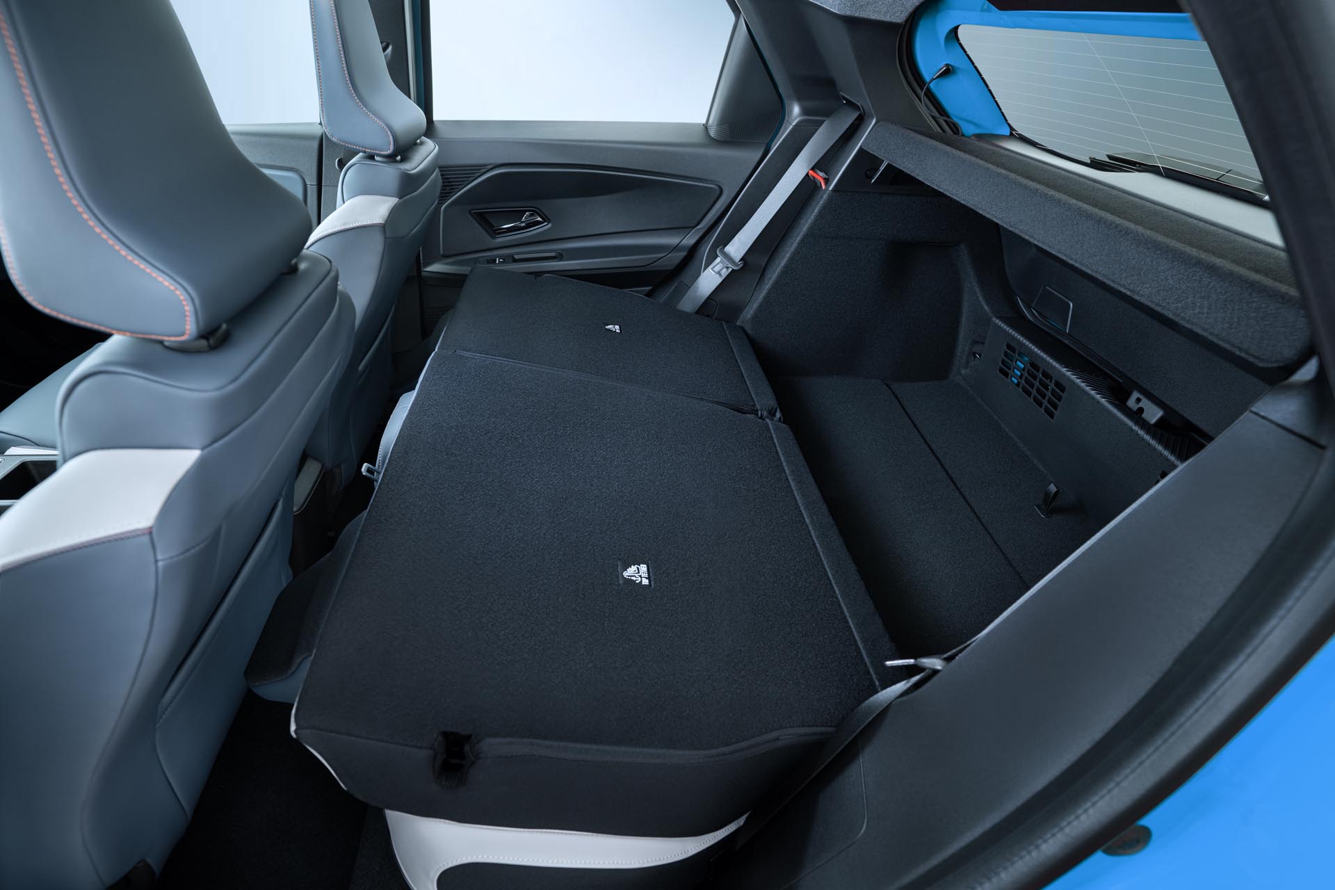 interior detail shot of collapsed rear seats revealing trunk space