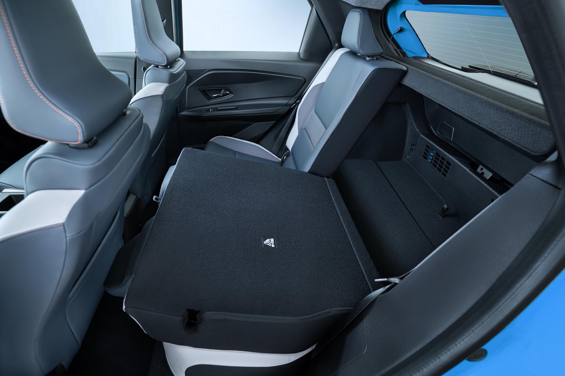 interior detail shot of one collapsed rear seat revealing trunk space