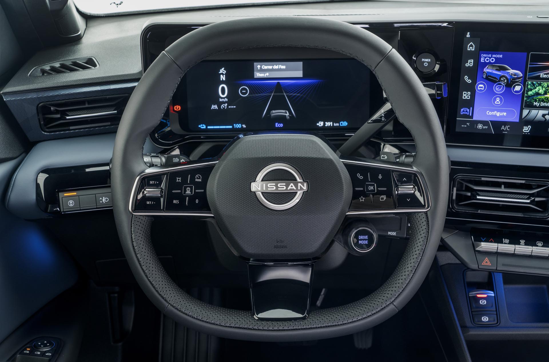 steering wheel detail showing Nissan logo combimeter and dials