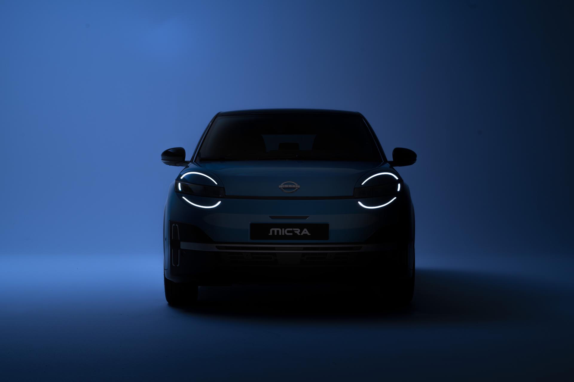 teaser image of All new Nissan Micra in the dark with only led signature headlamps in front on
